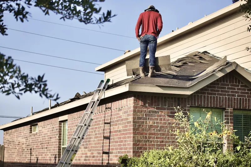 Professional roofer working on a residential roof in Sierra Sky Park